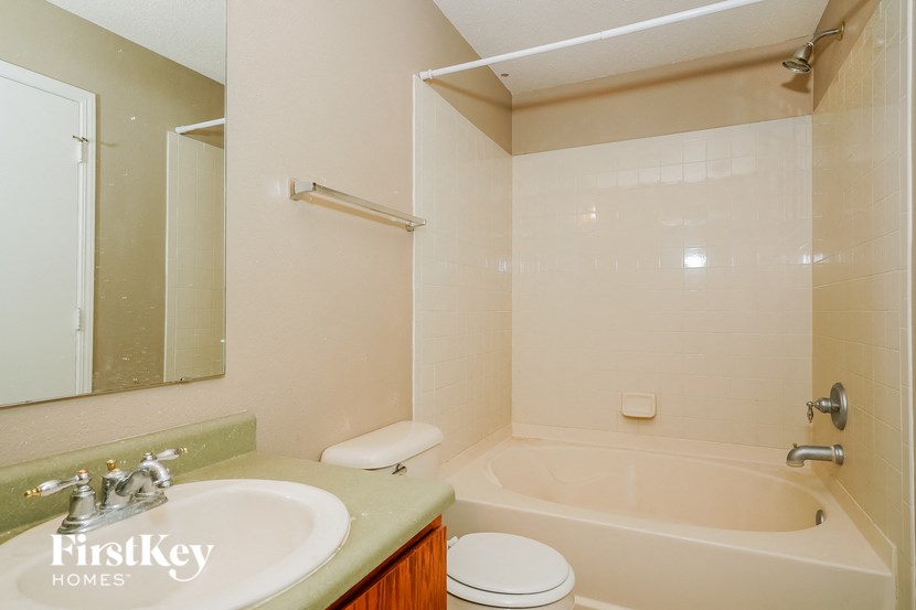 a bathroom with a sink toilet and a bath tub