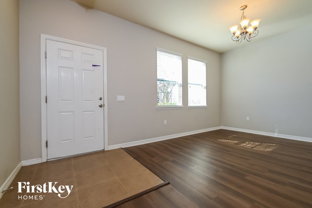 A room with a wooden floor and a white door.