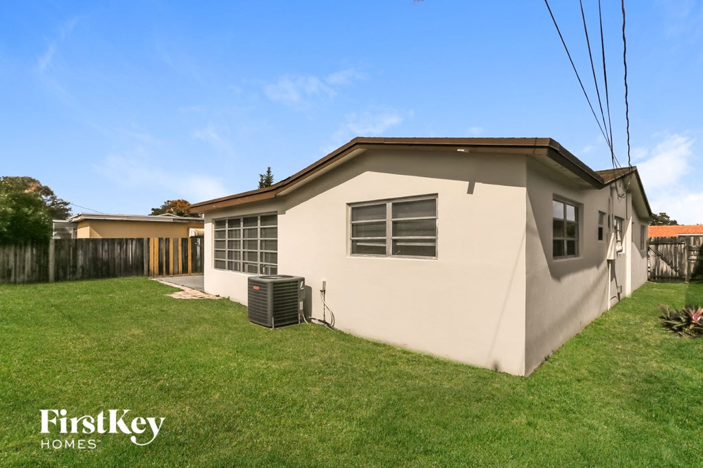 the exterior of a house with a yard and a heater