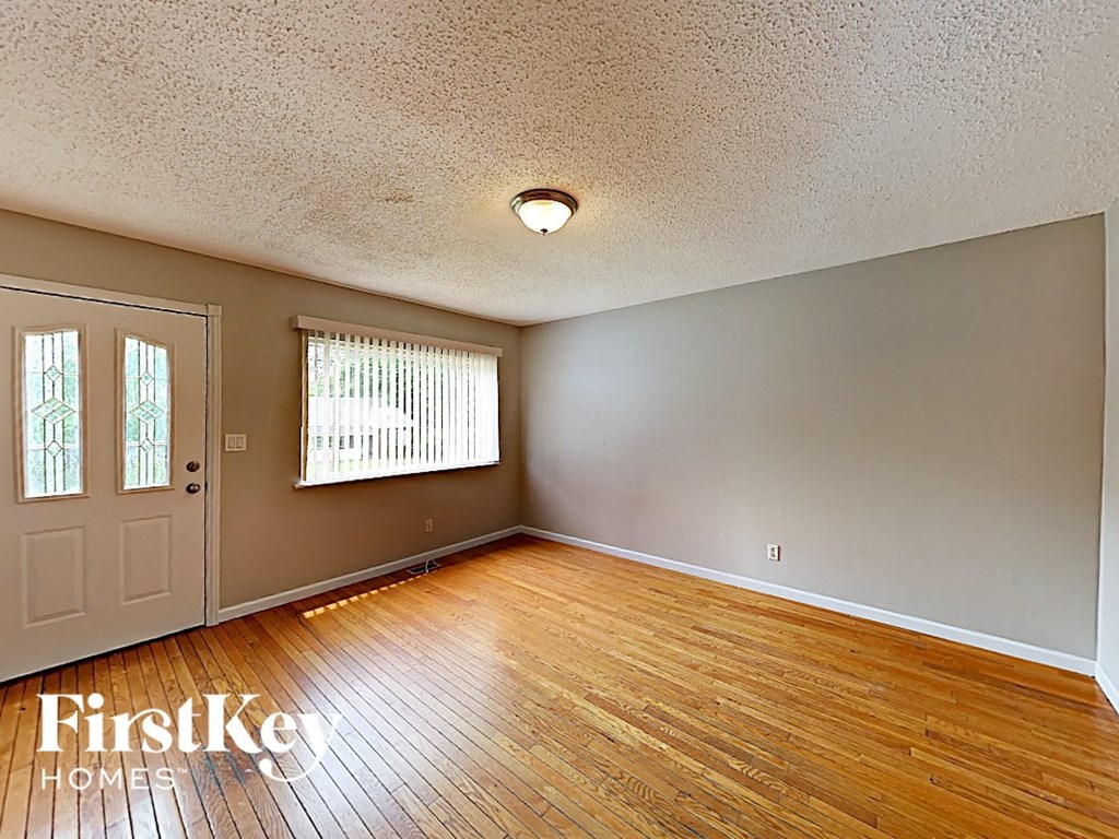 A room with wooden floors and a white door.