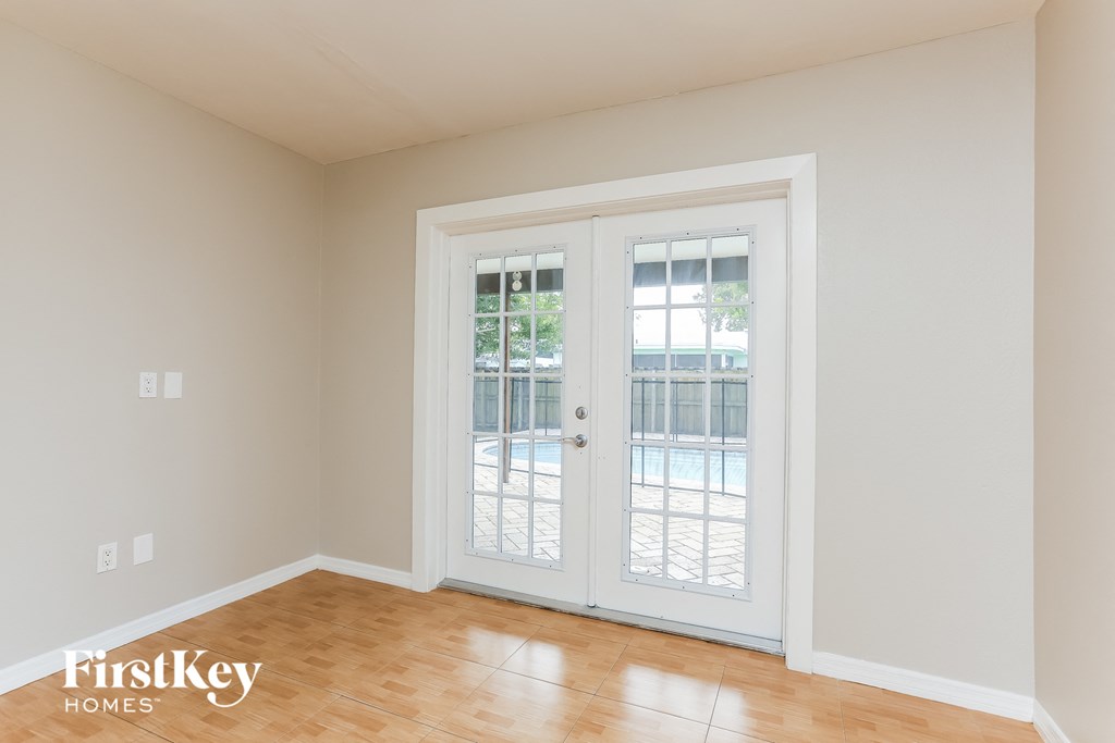 a living room doors and a wood floor