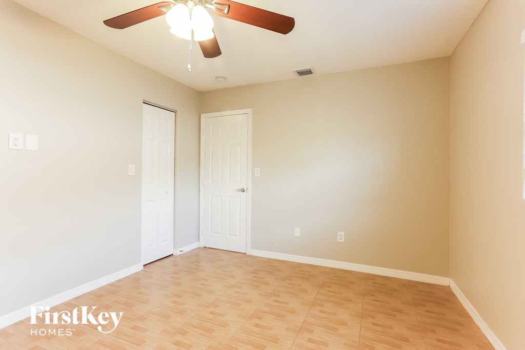 a living room with a wood floor and a ceiling fan