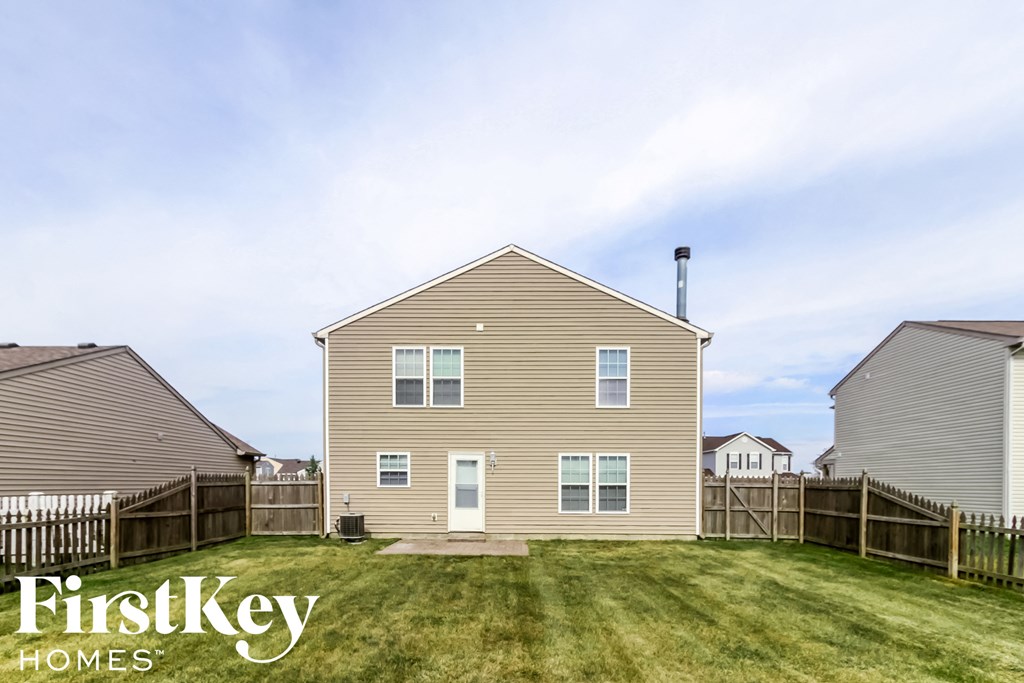 a house in a fisheye view with a yard and a fence