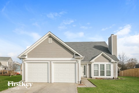 a house with a white garage door and a lawn
