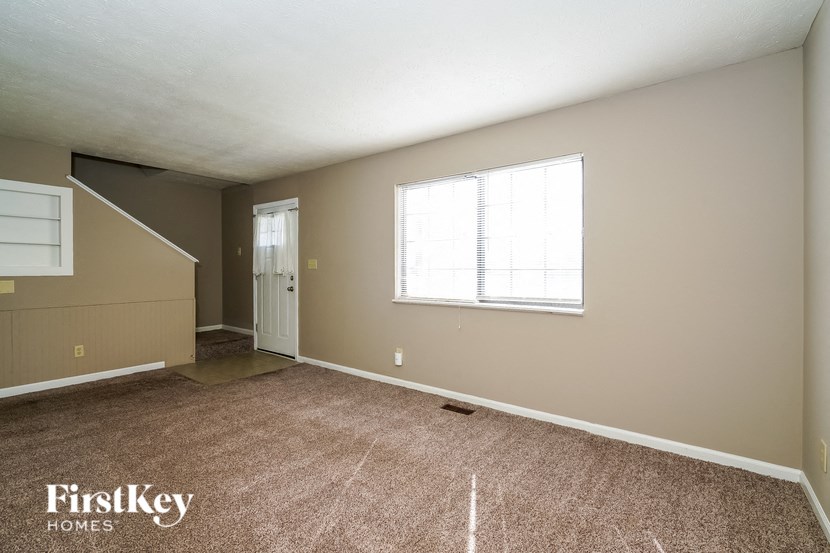 the living room of an empty house with a window