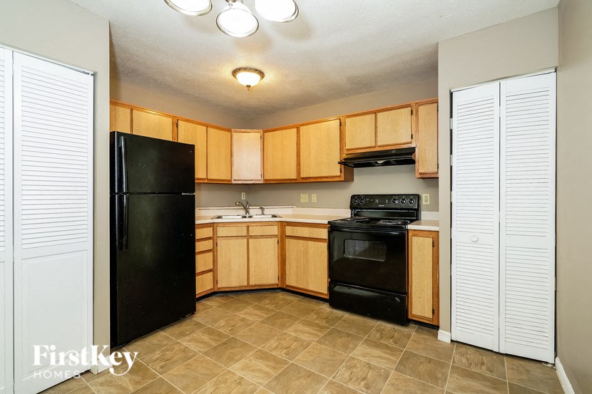 a kitchen with black appliances and wooden cabinets