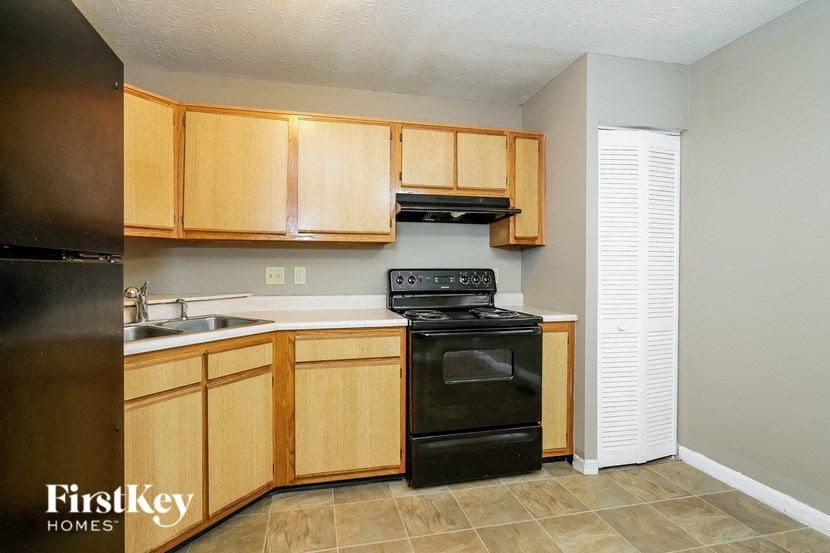 a kitchen with black appliances and wooden cabinets