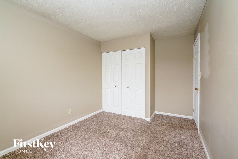 an empty room with a closet and a door