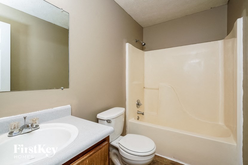 a bathroom with a sink toilet and a bath tub
