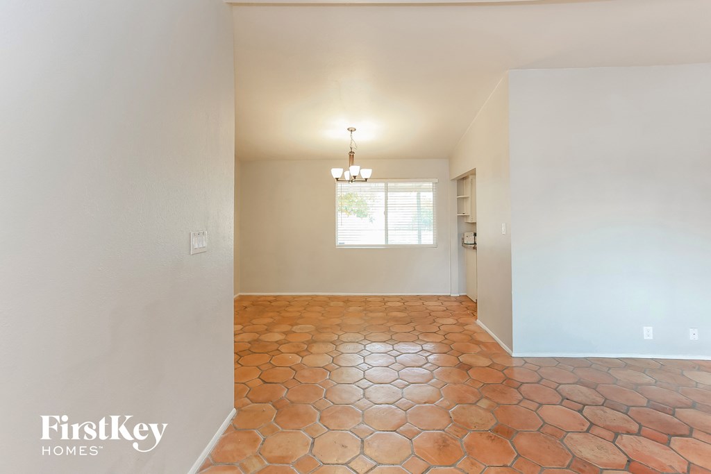 the living room and dining room of an empty house