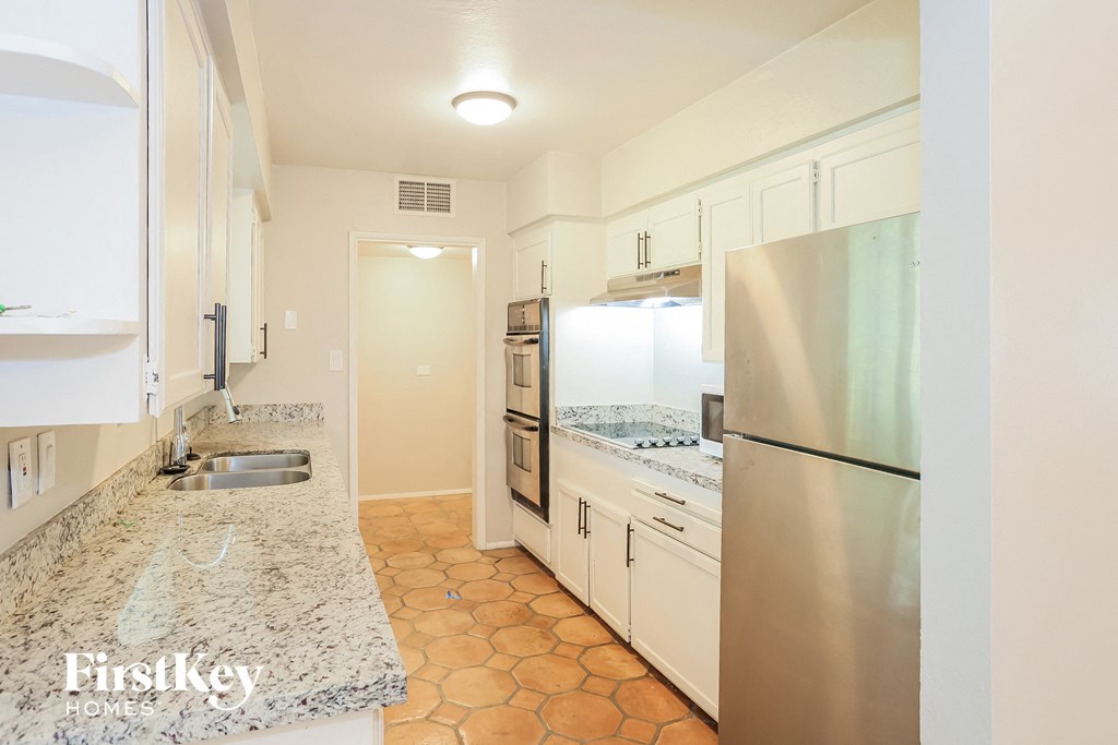 a kitchen with granite counter tops and stainless steel appliances