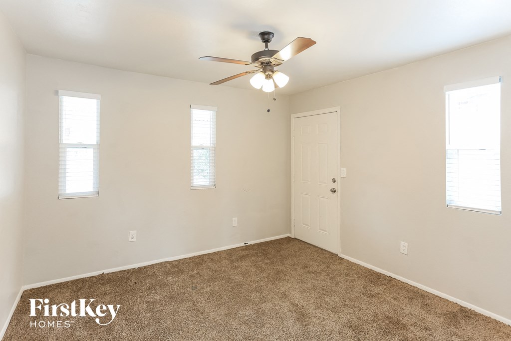 a bedroom with carpet and a ceiling fan