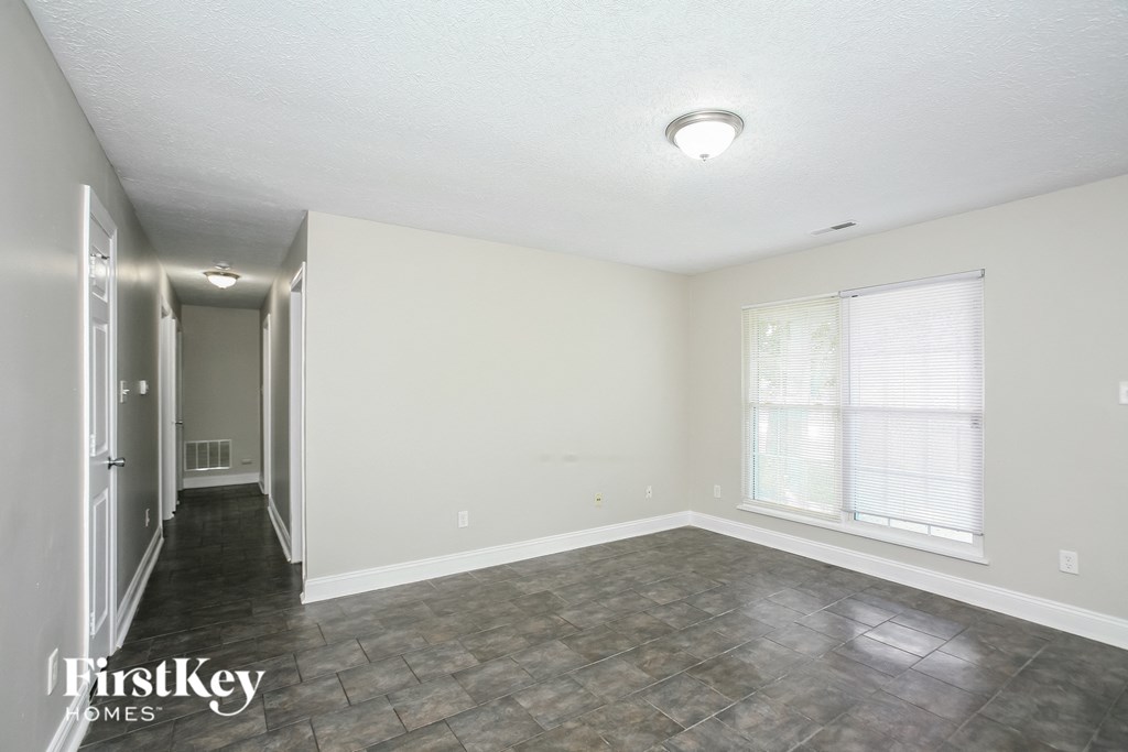 the living room of an empty house with a large window