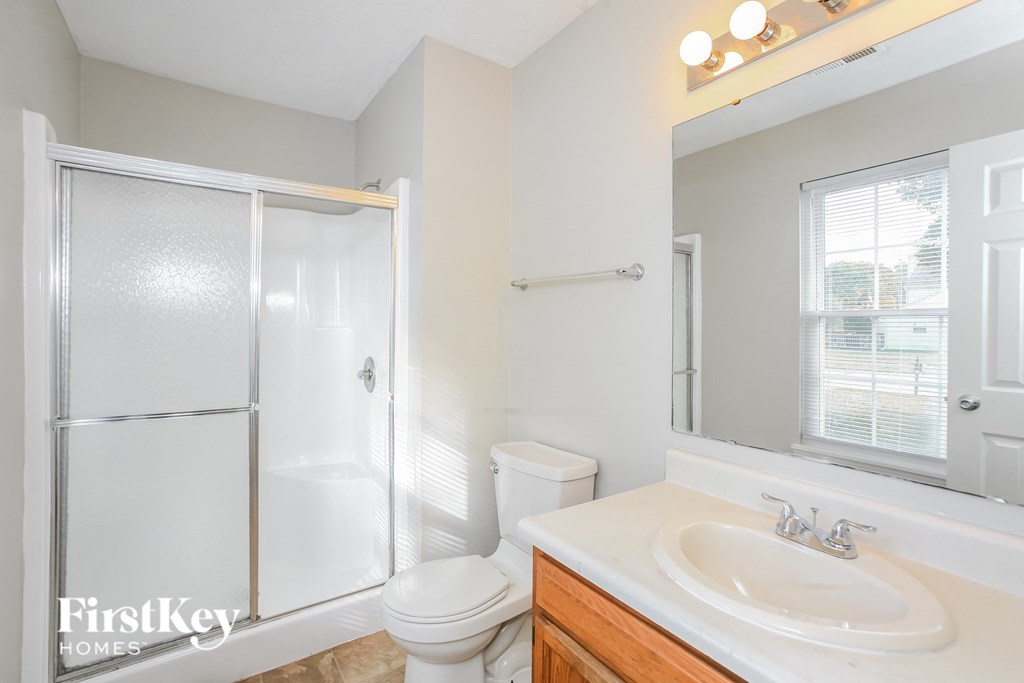 a bathroom with a sink toilet and a shower