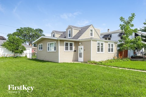 a beige house with a yard in front of it