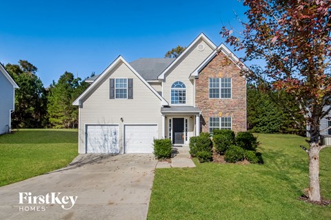 with brick and white siding and a white garage door