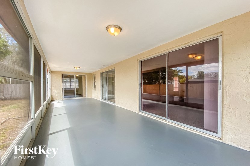 a long hallway with large windows and concrete floors