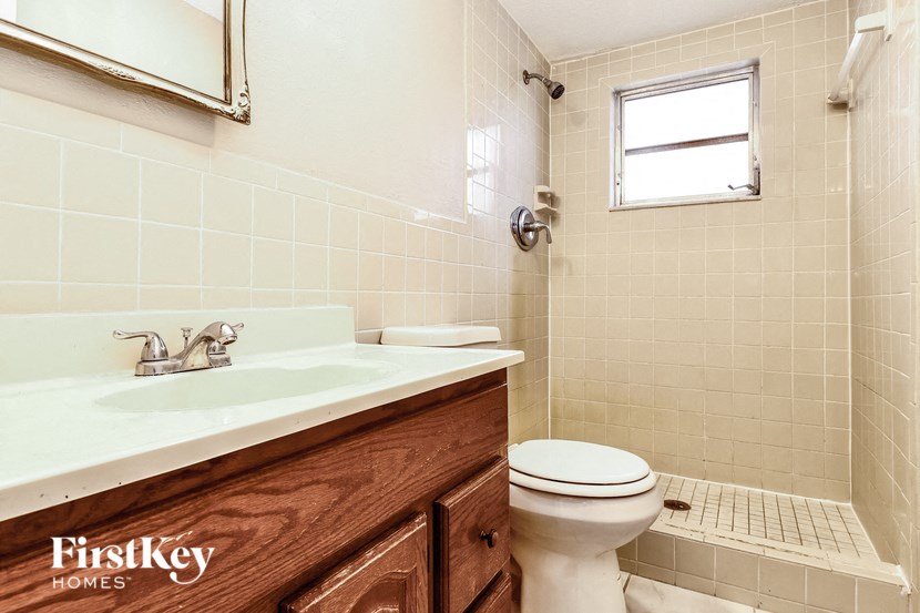 a bathroom with a white toilet and a sink
