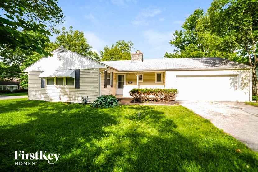 a white house with a yard and a white garage