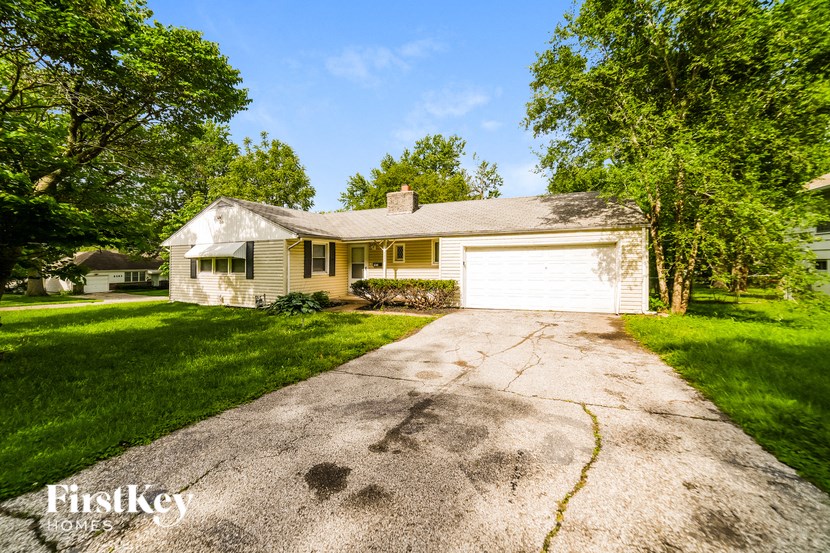 a white house with a driveway and a white garage door