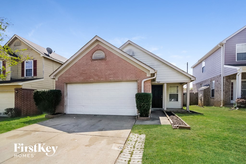 A house with a garage is for sale.
