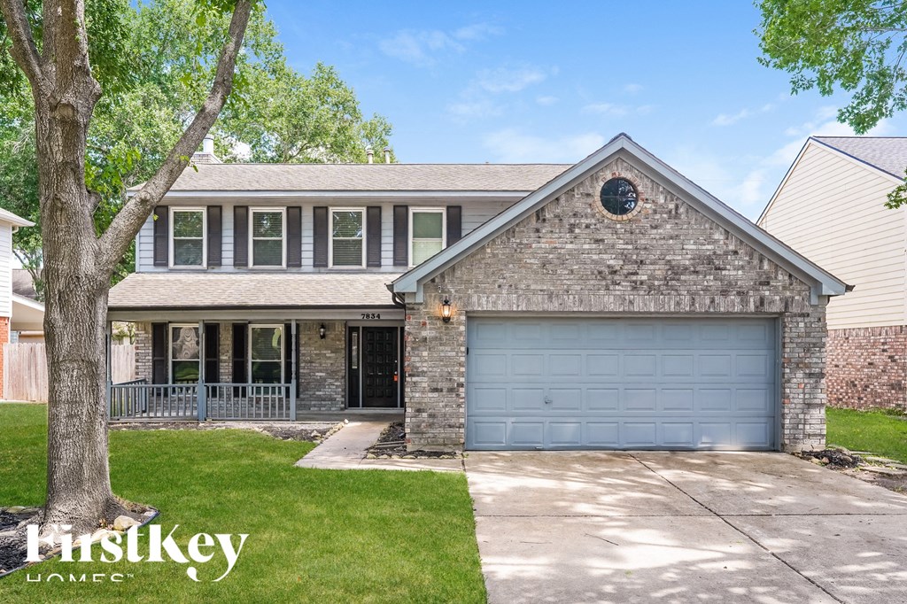 a brick house with a blue garage door
