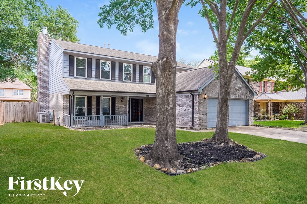 a house with two trees in front of it