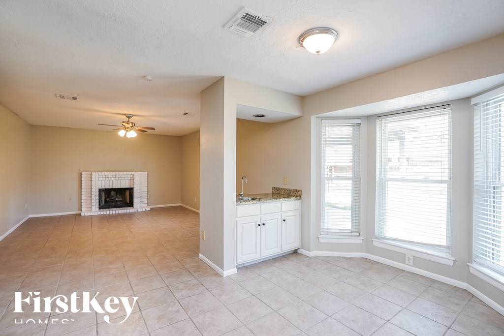 the living room and dining room with a fireplace