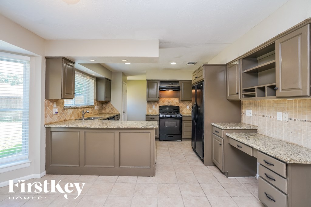 a kitchen with granite counter tops and stainless steel appliances