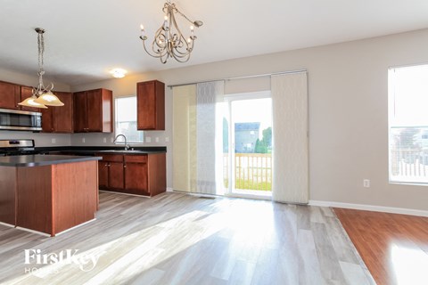 A kitchen with wooden cabinets and a black countertop.