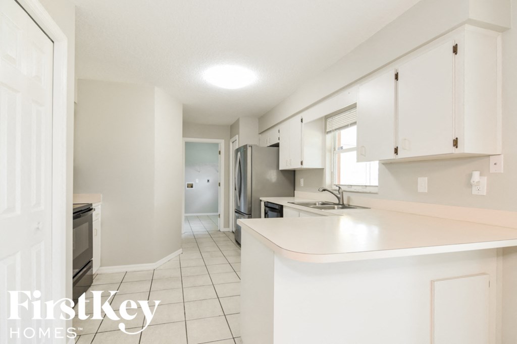 a white kitchen with white counter tops and white cabinets