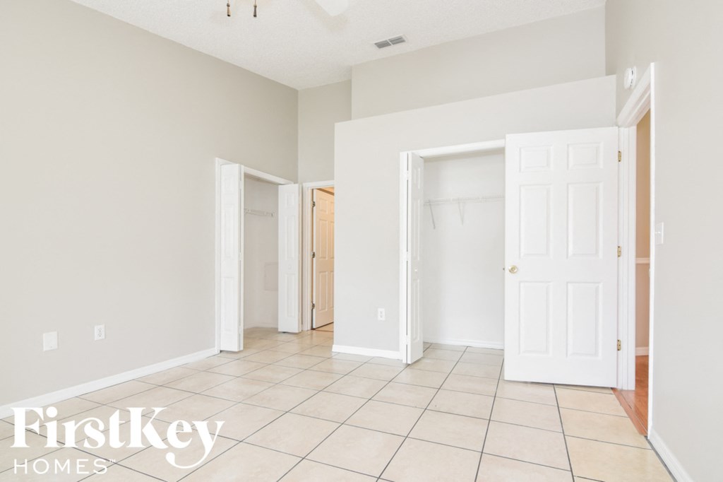 a large room with a tiled floor and a closet