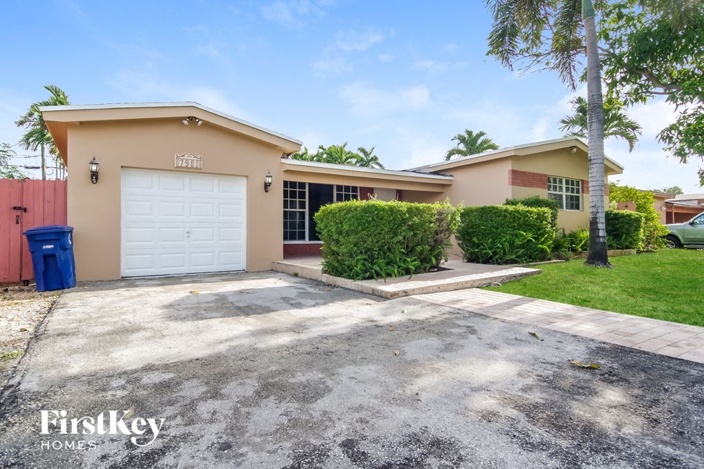 a house with a driveway and a white garage door