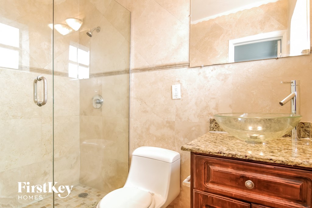 a bathroom with a toilet and a sink and a shower