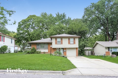 a small house with a yard and a sidewalk