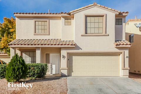A two-story house with a garage is for sale.