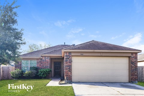 front view of a brick house with a garage door