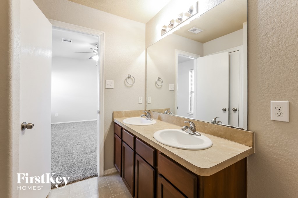 a bathroom with two sinks and a large mirror