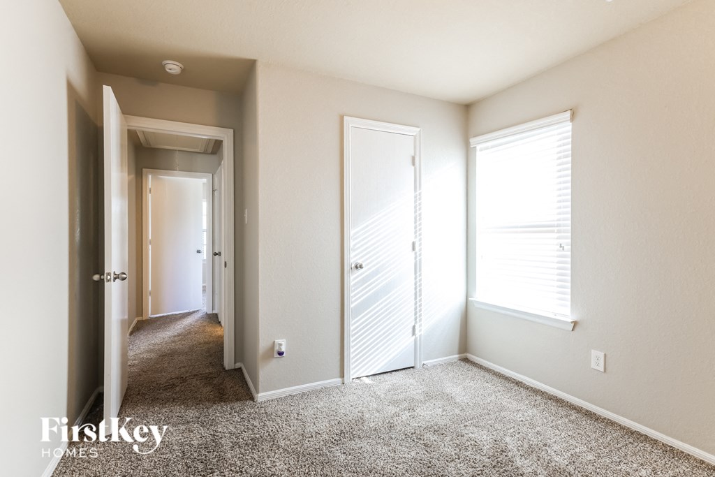 a bedroom with two closets and a door to a hallway