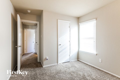 a bedroom with two closets and a door to a hallway
