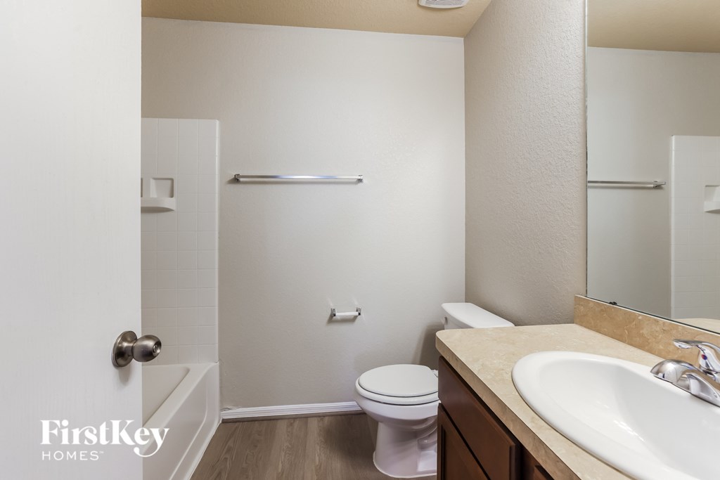 a bathroom with a toilet and a sink and a shower