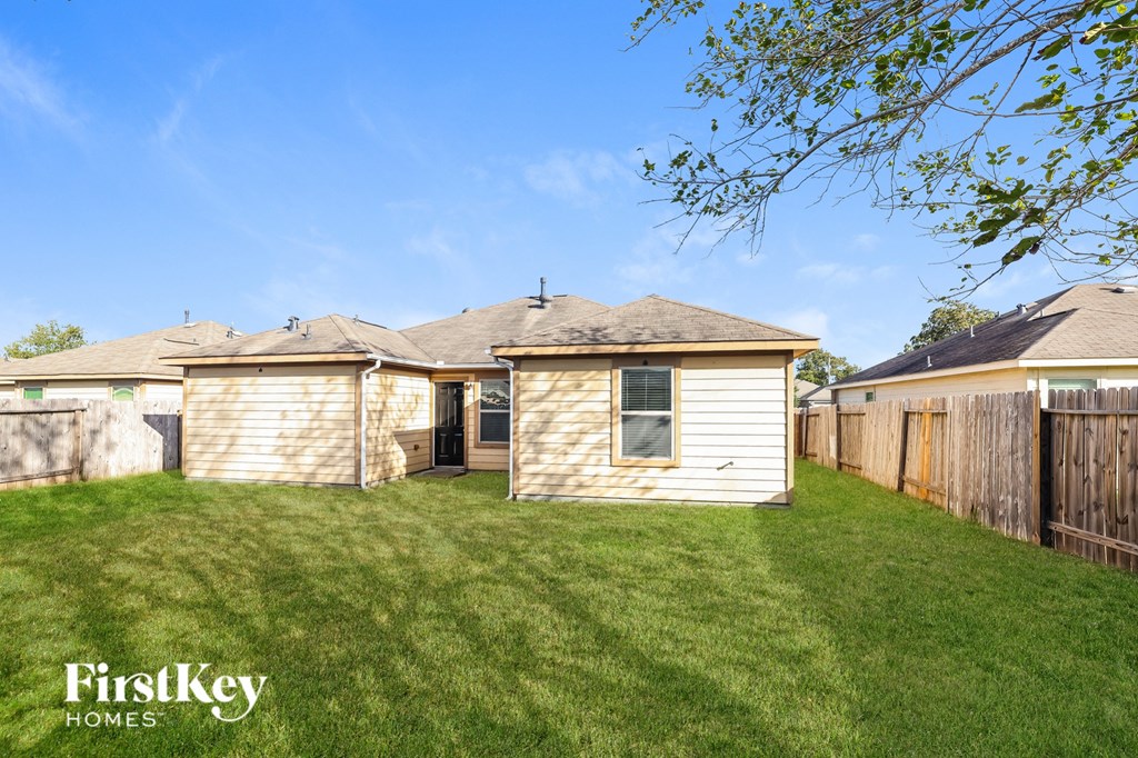 a backyard with a shed and a fence and a house