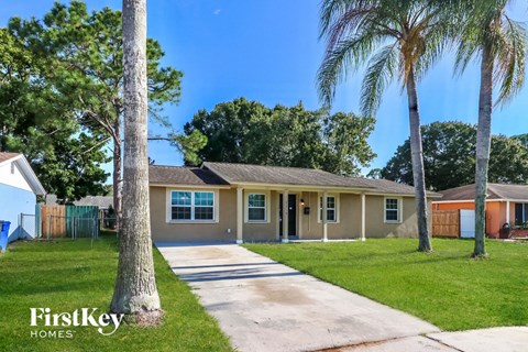A house with a tree in front of it.