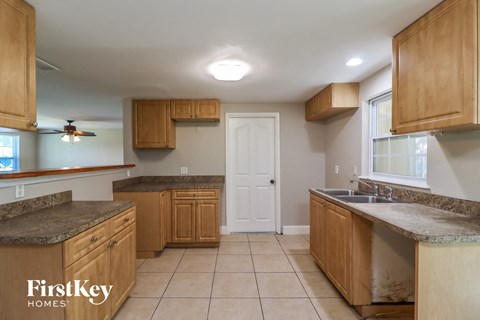 A kitchen with wooden cabinets and a countertop.