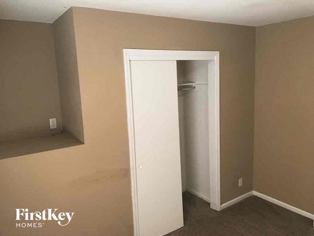 A room with a white door and a FirstKey Homes logo on the bottom left.