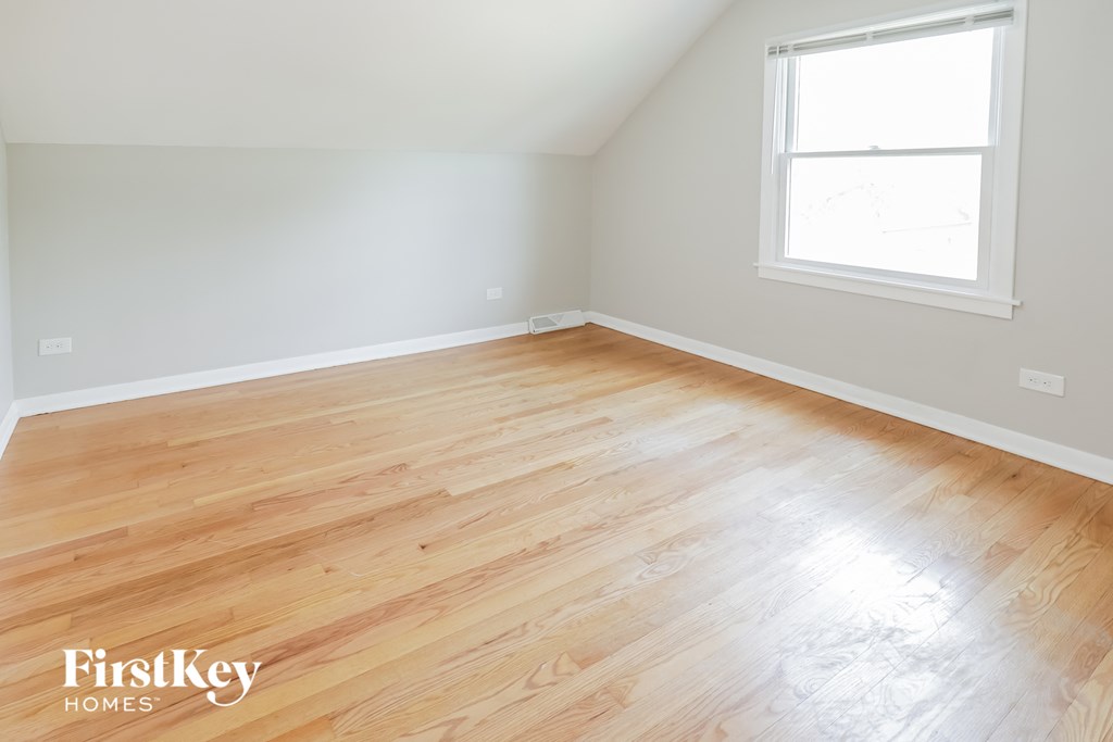 an empty room with wood flooring in a home