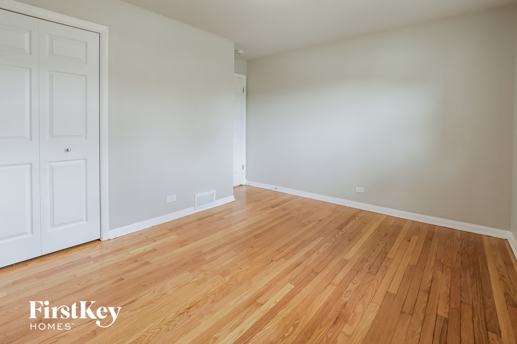 a living room with wood floors and white walls