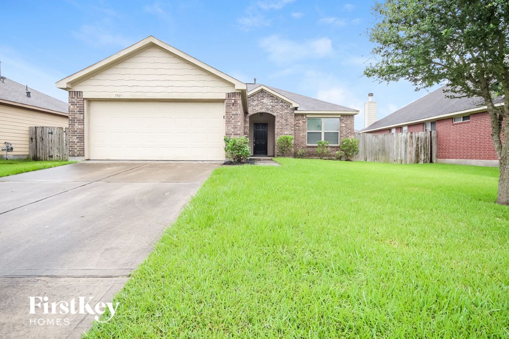 a home with a lawn and a driveway