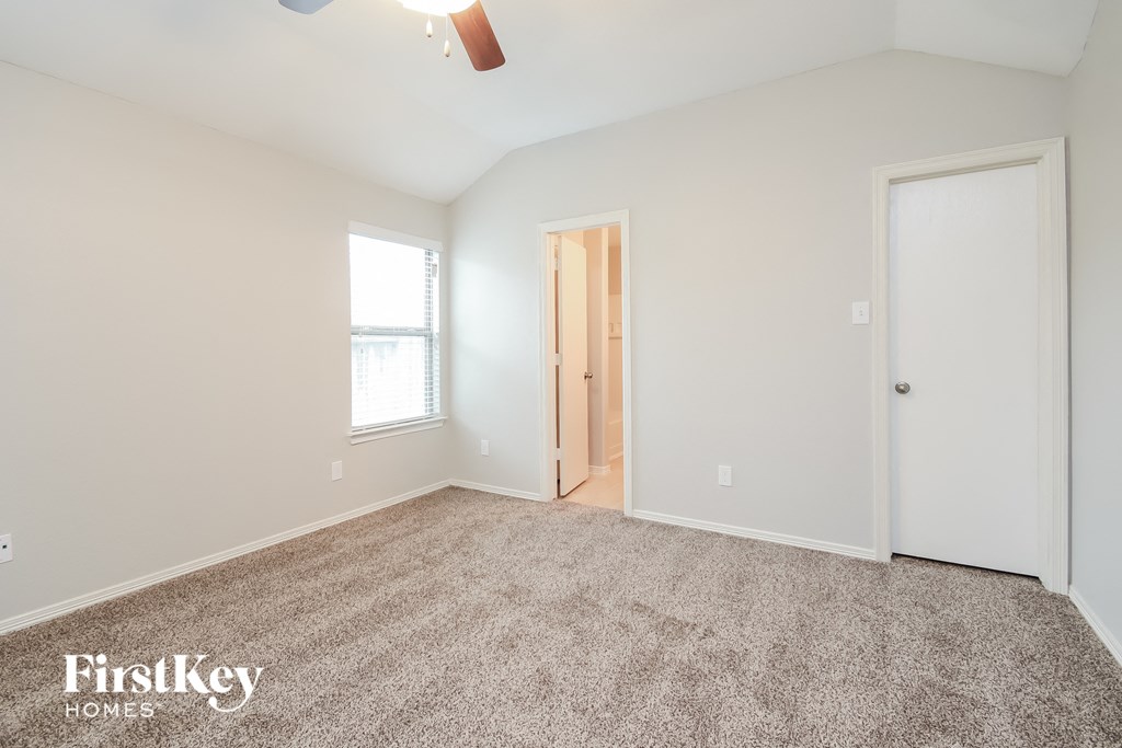 a bedroom with carpet and a door to a closet