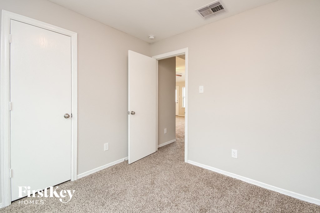 a bedroom with two closets and a carpeted floor